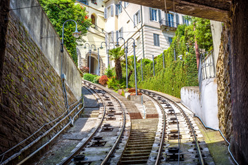 View to Citta Alta houses from tunnel of funicular, Bergamo, Italy. Funicular San Vigilio connects old Upper City and new. Scenery of rail road in the Bergamo historical center in summer.