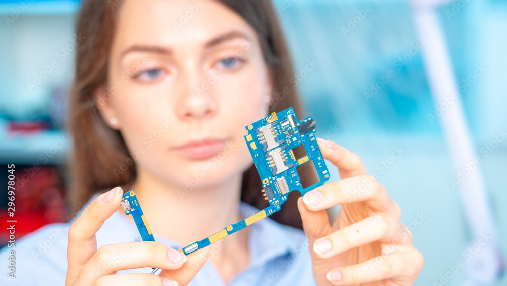 Sticker young woman in inspection electronics pcb devise. modern electronics laboratory