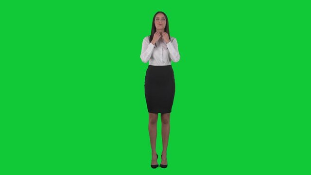 Young pretty business woman preparing and getting ready for work. Full body isolated on green screen chroma key background