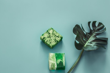 Spa still life on colored background with tropical leaves.