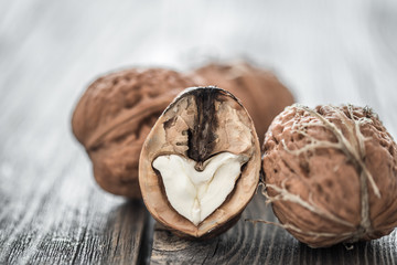 Walnut in open form on a wooden background, close-up .