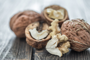 Walnut in open form on a wooden background, close-up .