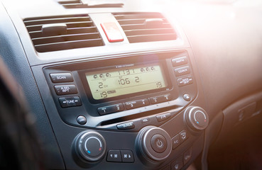 Close up image of car dashboard audio radio air conditioner console