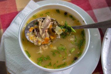 Closeup of a serving of veal soup with vegetables.