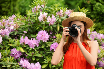 Photographer taking photo with professional camera in park