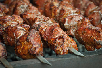 Barbecue fries in the coals. Meat and beef at the field kitchen festival.