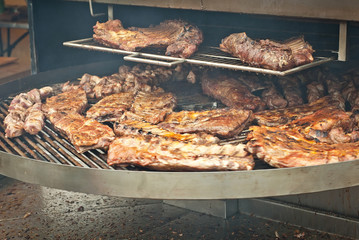 Barbecue fries in the coals. Meat and beef at the field kitchen festival.