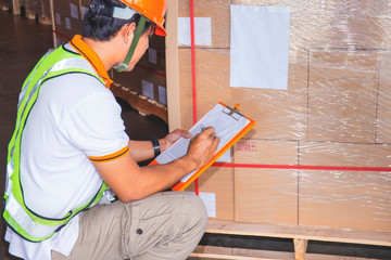 portrait of worker hand holding clipboard inventory checklist goods pallet 