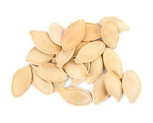 Pile of raw pumpkin seeds on white background, top view