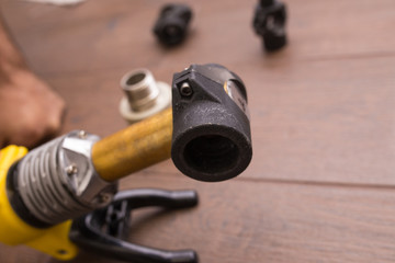 Soldering iron for a plastic water pipe close-up. The device stands heats the temperature.