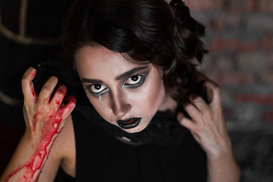 beautiful girl with black make-up, creative Halloween image, girl with black lace, preparation for the Latin-Mexican festival of the dead, for Halloween, for a masquerade