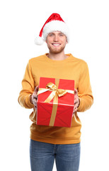 Young man with Christmas gift on white background