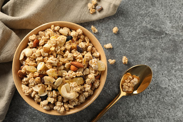 Bowl of tasty homemade granola on grey table, flat lay. Healthy breakfast