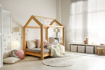 Cozy child room interior with comfortable bed