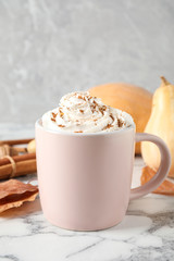 Obraz na płótnie Canvas Cup with tasty pumpkin spice latte on white marble table