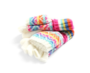 Warm knitted kid's mittens on white background