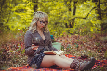 Autumn golden time, portrait of woman with a glass of wine at nature outdoors 