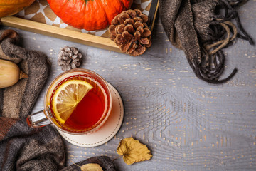 Fototapeta na wymiar Flat lay composition with cup of hot drink on grey wooden table, space for text. Cozy autumn atmosphere