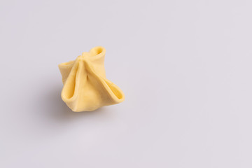 Fagottini Tortellini pasta isolated in white background, soft light, studio photo
