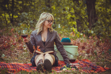 Autumn golden time, portrait of woman with a glass of wine at nature outdoors 