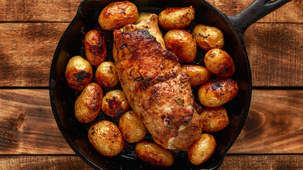 oven baked prune, rosemy and garlic stuffed pork fillet with baby potatoes