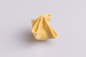 Fagottini Tortellini pasta isolated in white background, soft light, studio photo