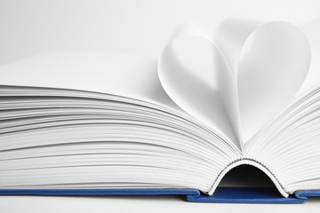 Closeup view of open book on white background