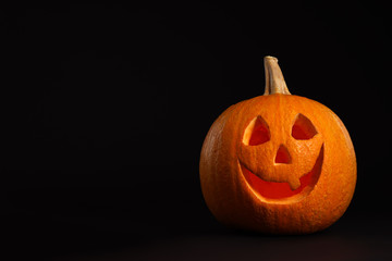 Pumpkin head on black background, space for text. Jack lantern - traditional Halloween decor