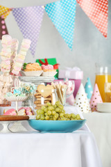 Fototapeta na wymiar Candy bar with delicious treats for birthday party