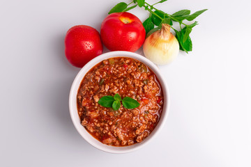 Bolognese (also know as Bolognesa or Bolonhesa) sauce in a white bowl isolated in white background, soft light, studio photo, copy space