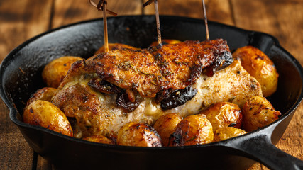 oven baked prune, rosemy and garlic stuffed pork fillet with baby potatoes