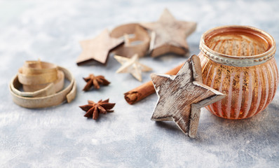 Christmas decoration (wooden Stars and spices) on bright background. Close up. 
