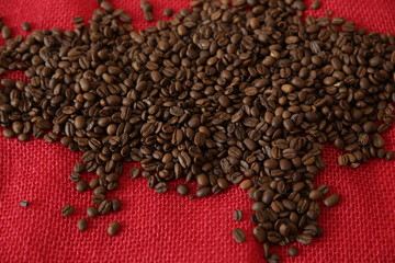 organic coffee beans on red burlap background. Coffee concept.