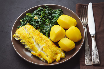 Pan-fried cod fillet, served with spinach and potatoes.          
