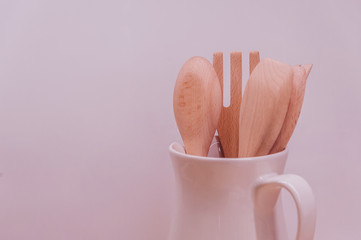 Fototapeta na wymiar Kitchenware set of wooden spoon and fork on white background..Wooden spoon & fog with long handle isolated on pink background