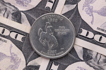 Symmetric composition of US dollar bills and a quarter of Wyoming.