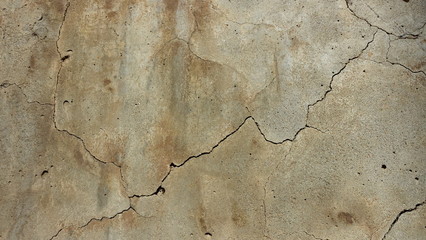  A crack on the concrete wall surface of a house in Los Angeles. Background image for design