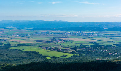 Slovakia landscape. On the horizon visible range of the Low Tatras. Before them in the lowlands are several cities (including Poprad), meadows, forests and fields.