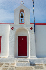 One among the beautiful churches in the town of mykonos Greece bathing in sunshine