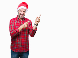 Middle age hoary senior man wearing christmas hat over isolated background smiling and looking at...