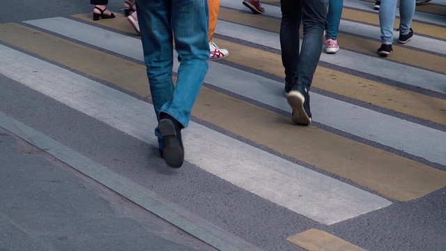 People cross the road on the pedestrian crossing Zebra in slow motion
