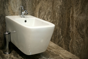 Toilet and bide bathroom isolated on black background.