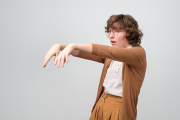 exhausted zombie like woman standing in studio being extremle tired or exhausted. Studio shot