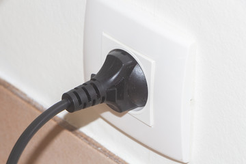 Plug in a socket in the wall of an house