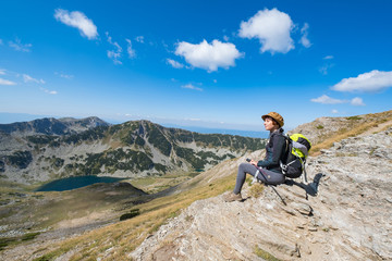 Fototapeta premium Young woman traveler in the bulgarian mountains , hiking in the sunny day