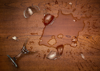 Shattered wine glass on floor. Top down view.