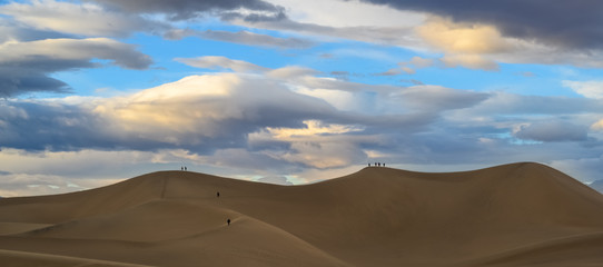 Fototapeta na wymiar Climbing the sand dunes in the desert