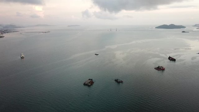 Aerial ship, vessel on the Straits of Malacca near Penang. Penang bridge at the background.