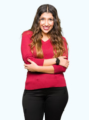 Young beautiful woman wearing red sweater happy face smiling with crossed arms looking at the camera. Positive person.