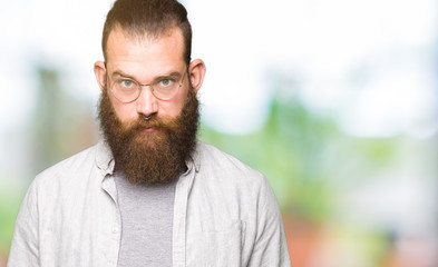 Fototapeta premium Young blond man wearing glasses skeptic and nervous, frowning upset because of problem. Negative person.